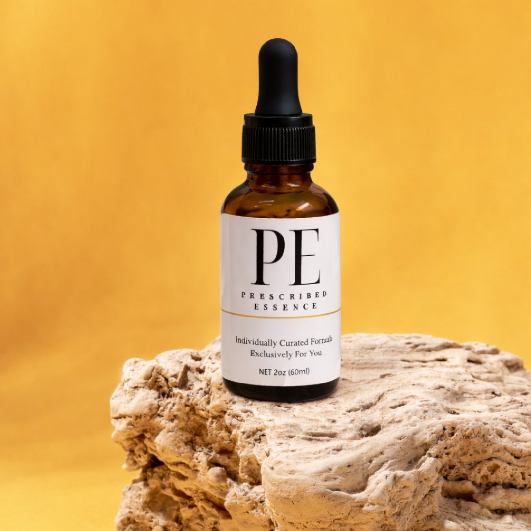 Amber Prescribed Essence bottle on a rock, yellow background