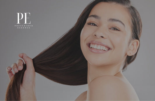 Smiling woman holding her long dark hair